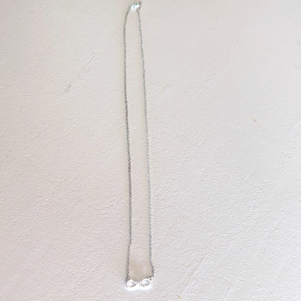 Elegant Silver Necklace Infinity Charm with clear stones.